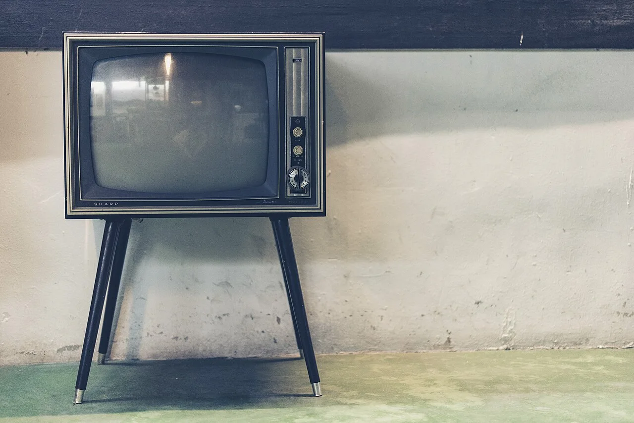 A vintage television on a slender stand