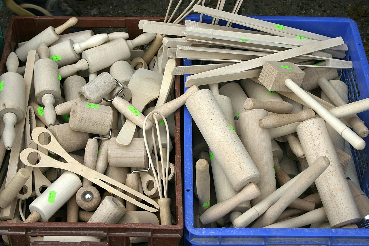 A collection of wooden rolling pins and kitchen utensils