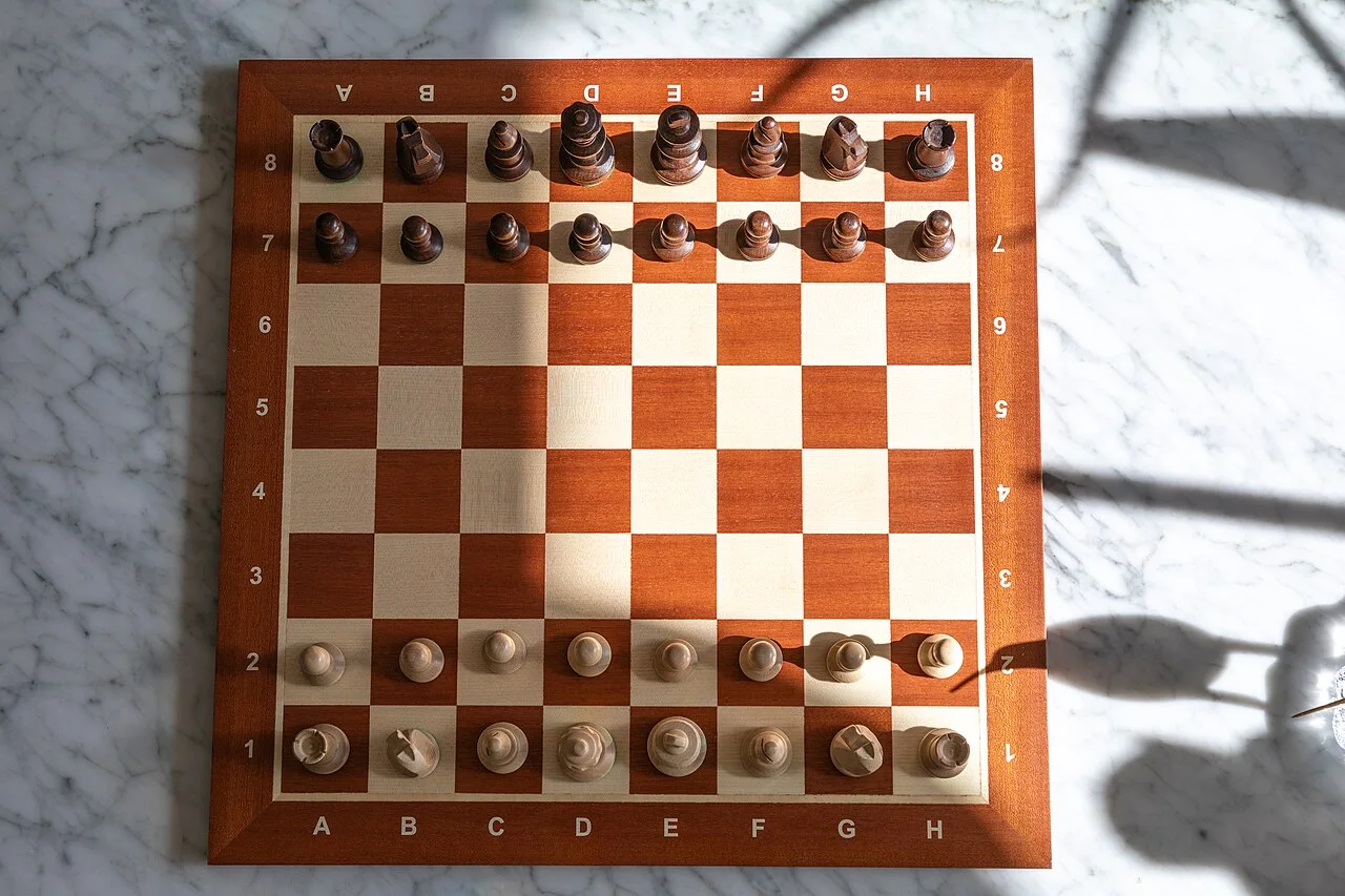 A chessboard with wooden chess pieces