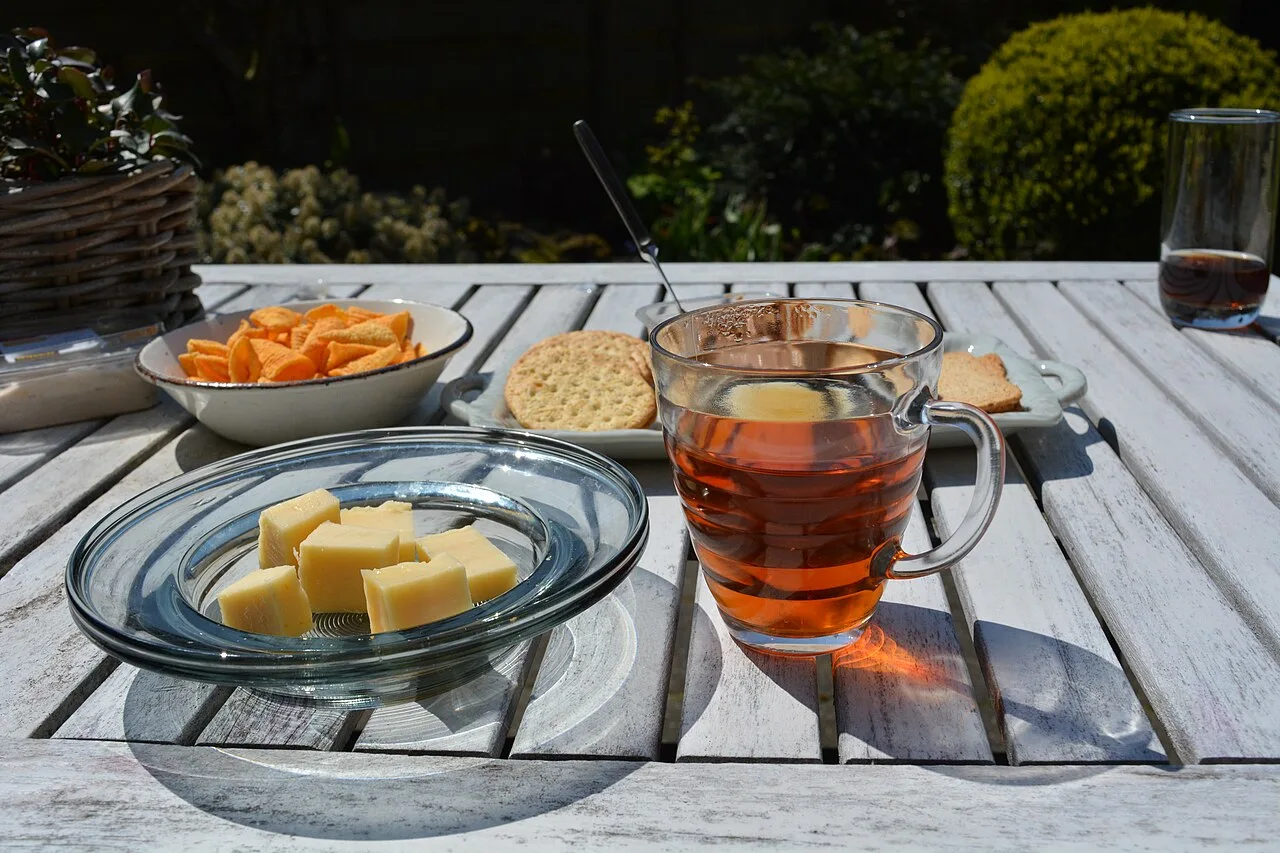 Tea and snacks on a sunlit outdoor table