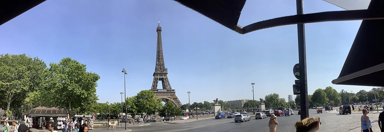 The Eiffel Tower rising above a Paris street